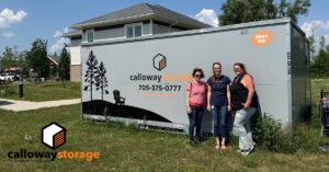 Calloway staff in front of container with Lighthouse staff